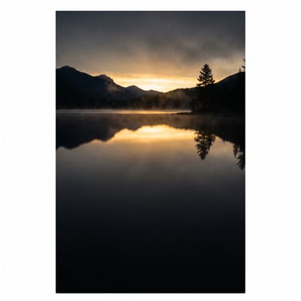 Still, calm water reflecting a golden sunrise.